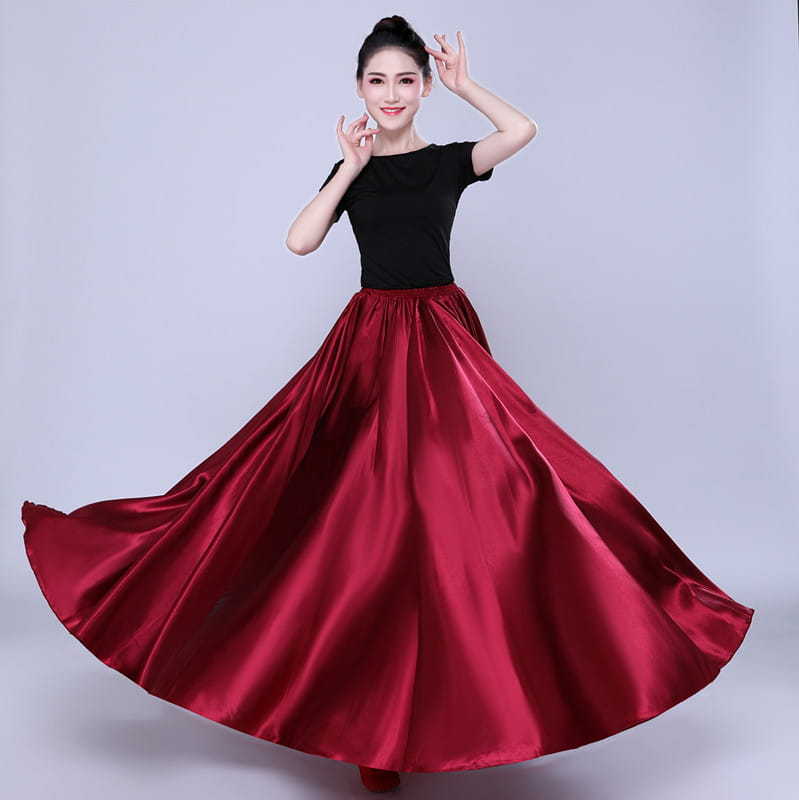 A flowing deep red satin simple solid color performance skirt with a high waist and full elegant flare.