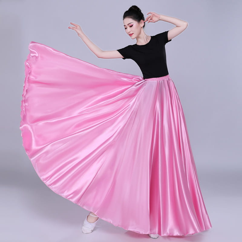a flowing vibrant pink satin skirt with a high waist and full pleated design in a simple solid color performance style