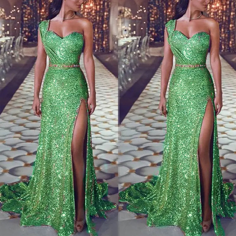 a shimmering emerald green sleeveless bronzing split dress featuring a one shoulder design, sweetheart neckline, and high slit made of sequined fabric