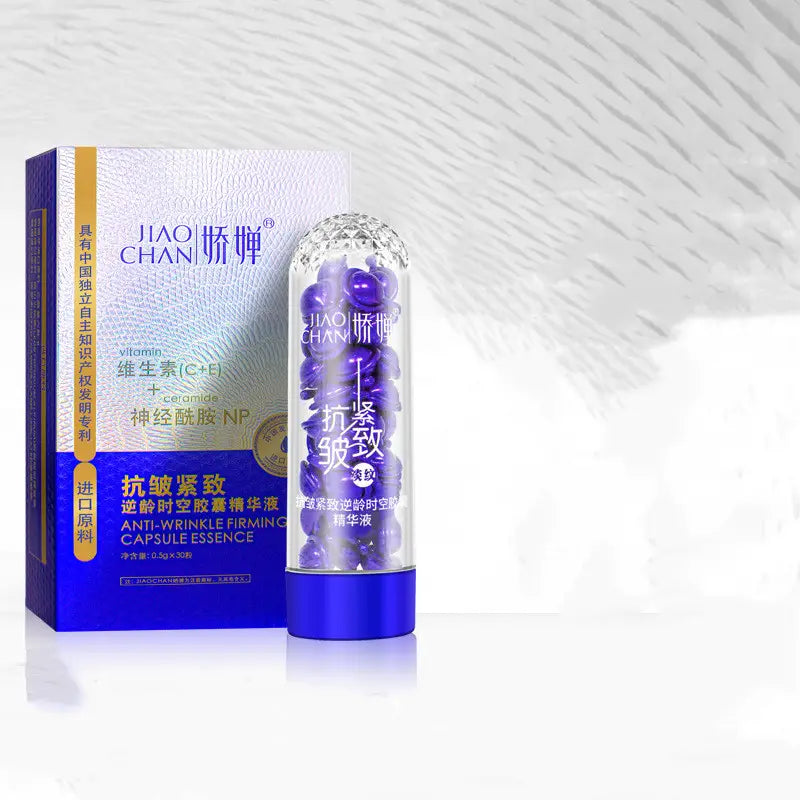 a transparent cylindrical tube with a blue base and cap filled with purple jiao chan anti-wrinkle firming capsules labeled as blue big chicken leg anti aging essence capsules