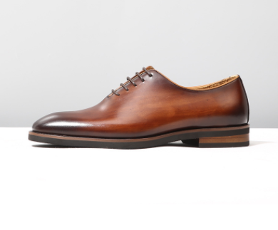 Brown leather oxford shoes for men with a polished classic design and dark laces ideal as wedding shoes.