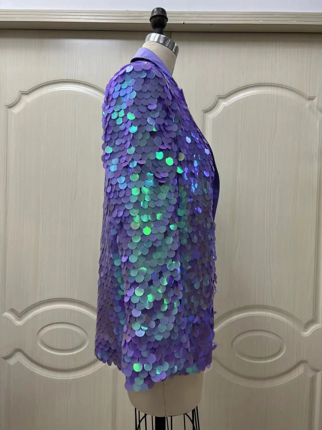 a lavender sequin fashion suit blazer featuring a shimmering purple fabric with iridescent green and blue highlights made from densely packed circular metallic scales perfect for high dinner party wear and loose sequin fashion styles