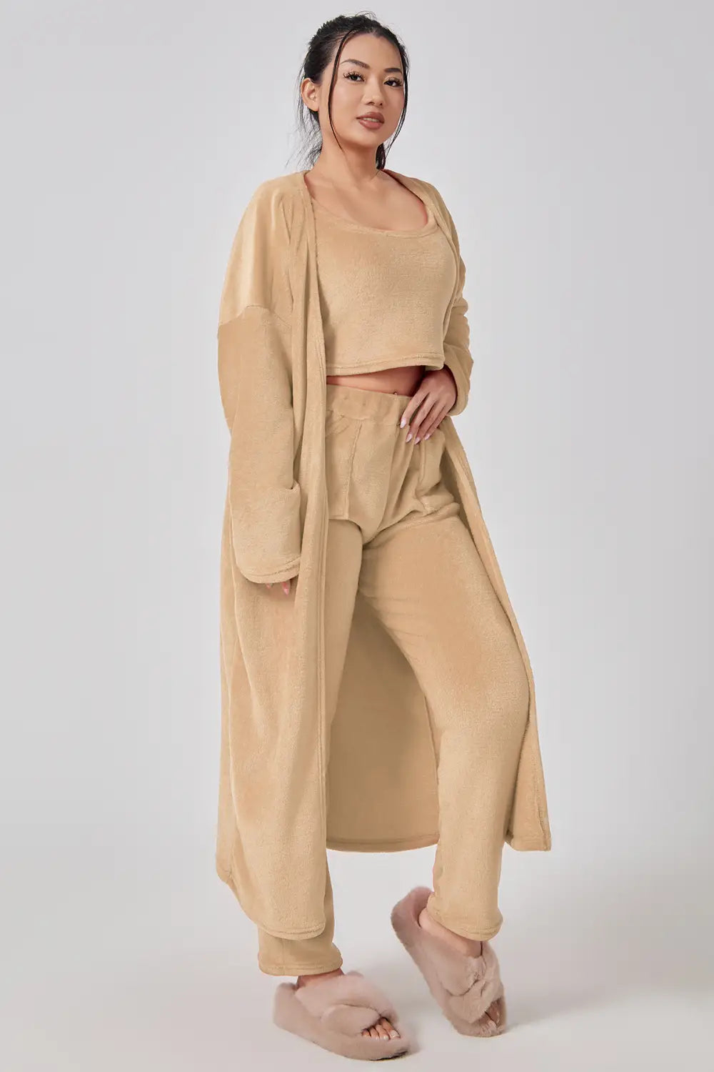 beige velvet three-piece lounge set featuring a long robe, crop top, and tapered pants in a cozy pajama set perfect for relaxation.