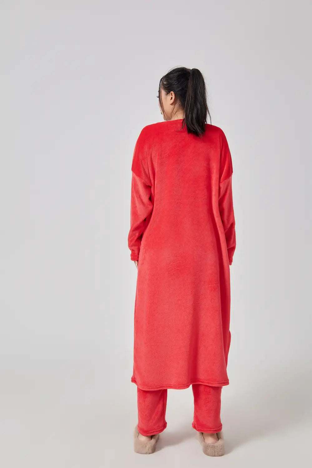 A vibrant red plush long-sleeved robe with a relaxed fit and matching pants as part of a cozy pajama set lounge set.