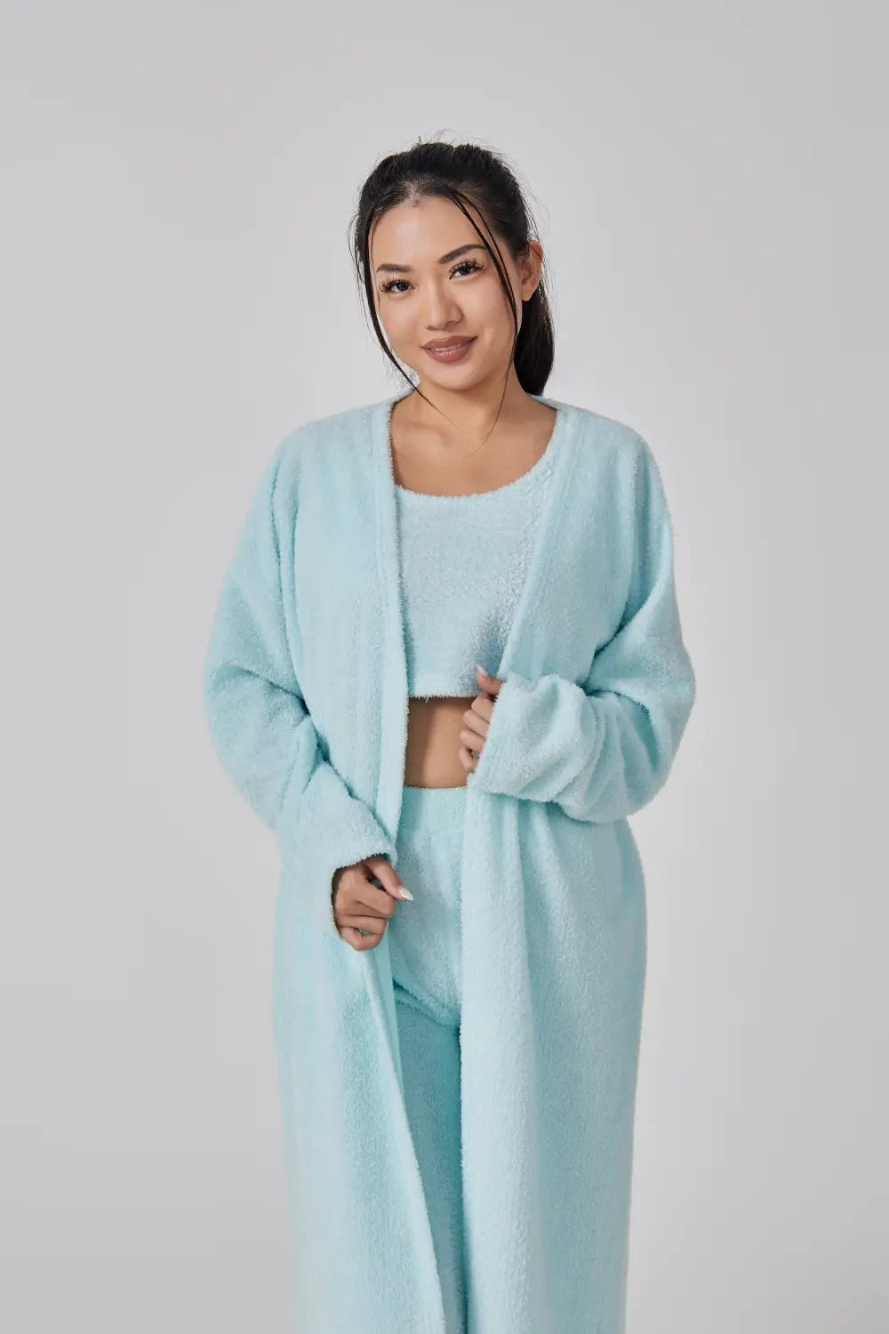 a soft light blue plush knit three piece lounge set featuring a long cardigan and matching pants ideal for a cozy pajama set.