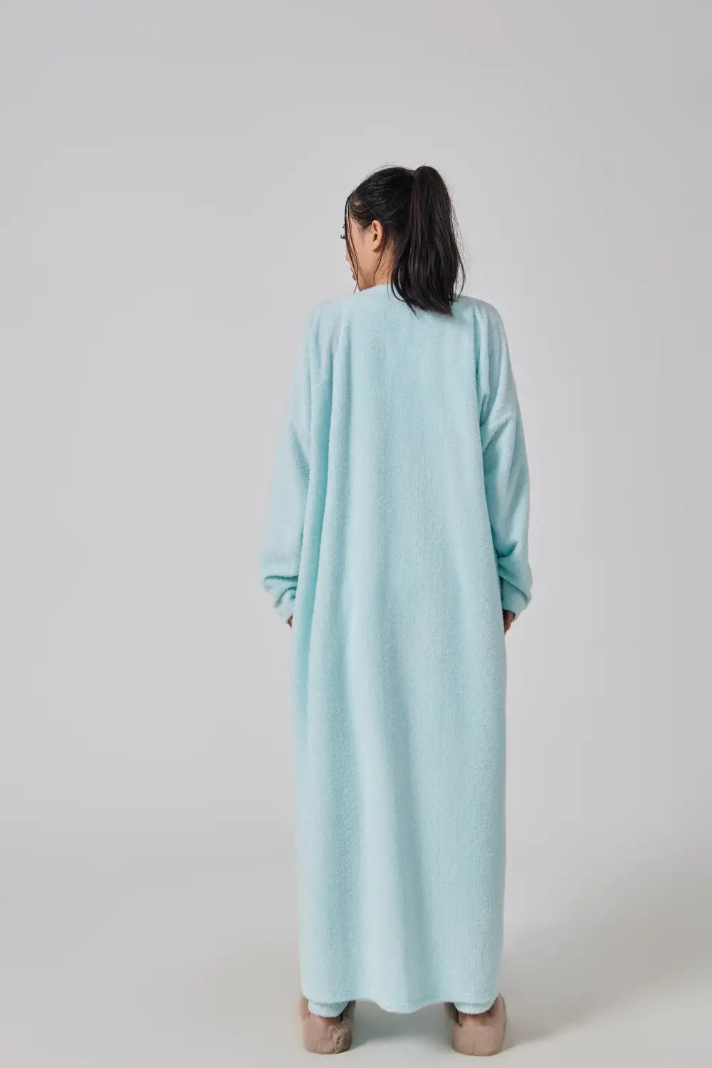 A soft light blue floor-length robe with long sleeves and a relaxed fit as part of the blue shimmer 3 piece lounge set cozy pajama set.