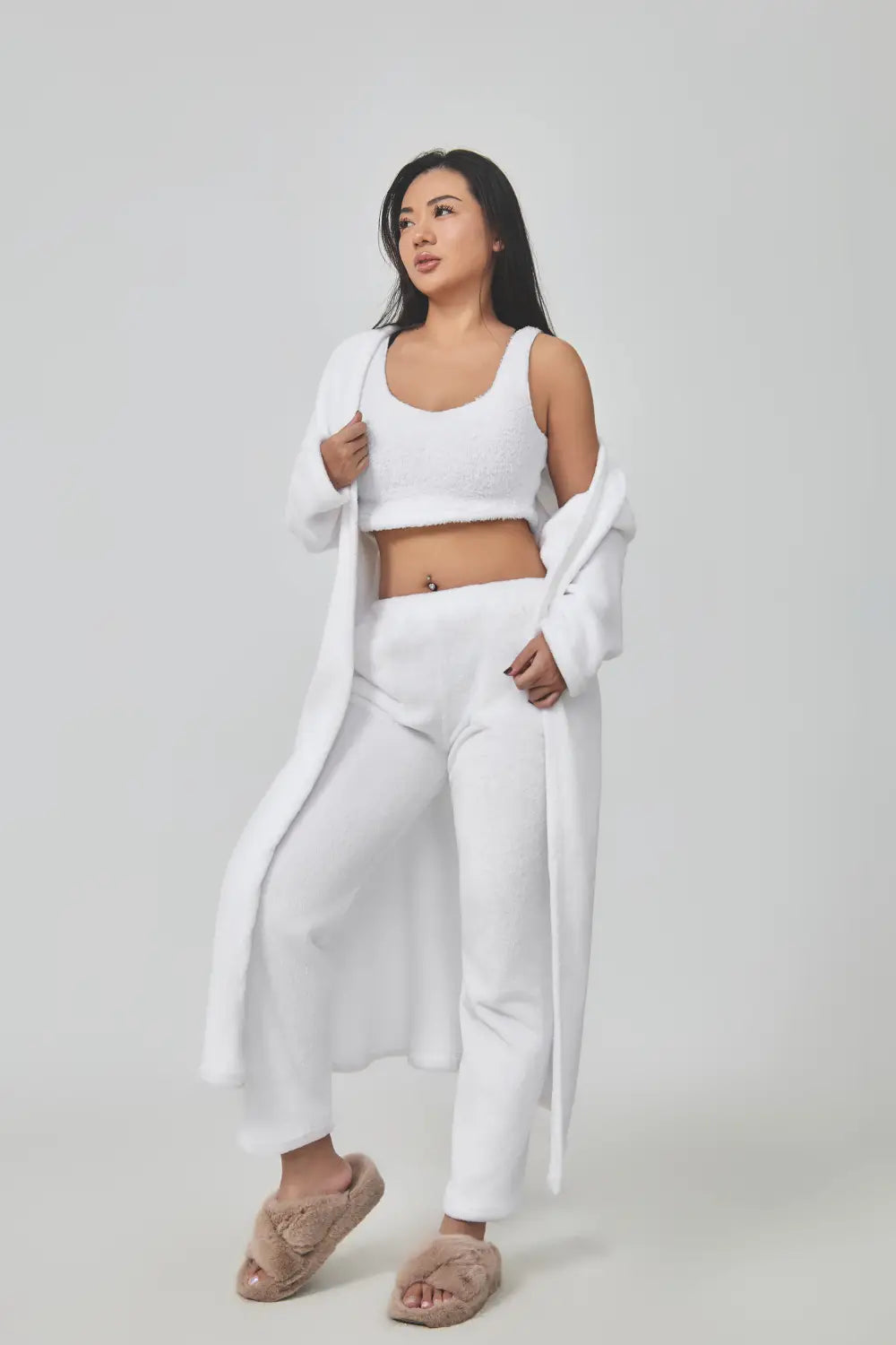 white knit crop top with matching pants and long robe paired with fuzzy beige slippers in the blue shimmer 3 piece lounge set cozy pajama set
