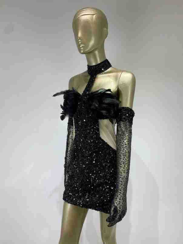 black halter feather sequins short mini dress in black sequined fabric with feather embellishments paired with sheer mesh gloves