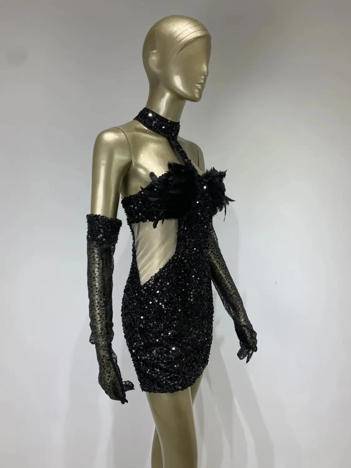 black halter feather sequins short mini dress in black sequined fabric with feather embellishments and matching long gloves.