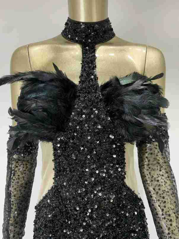 black halter feather sequins short mini dress featuring a black sequined gown with feathered shoulder accents and sheer long sleeves.