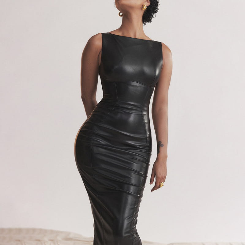 A sleek black american style women dress featuring a fitted bodice and ruched detailing in a PU leather skirt with a leather skirt silhouette.
