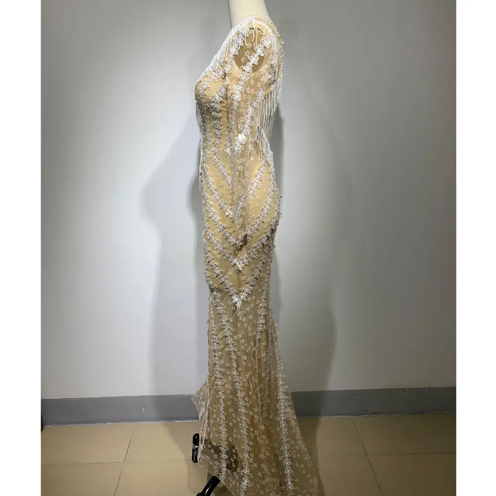 a shimmering champagne-colored backless tight fishtail gown featuring intricate white lace, delicate beading, and a sheer overlay cascading down the back
