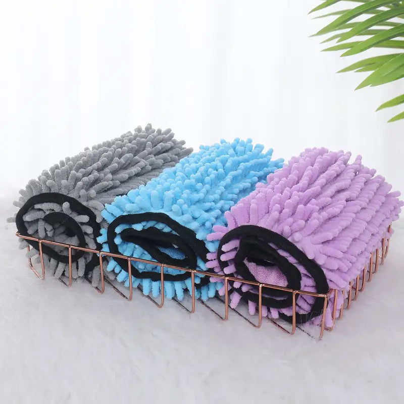 three rolled-up super absorbent microfiber bath towels for dogs cats in gray blue and purple with black elastic bands