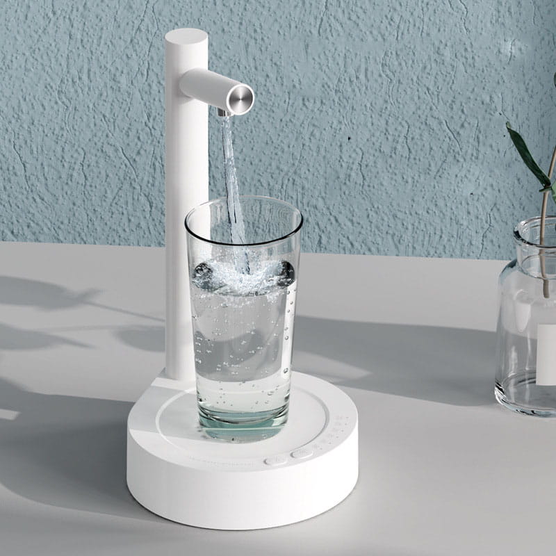 white minimalist water dispenser with sleek cylindrical spout pouring clear liquid into a glass in dark blue smart desk dispenser electric water model