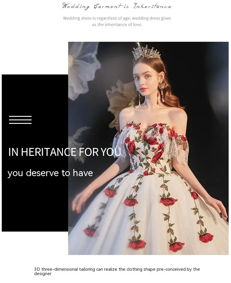 A white off-the-shoulder wedding dress featuring intricate red rose embroidery and delicate lace detailing designed as a temperament bride bra with bride bra trailing accents.