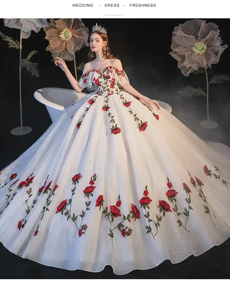 A white wedding dress with intricate red rose embroidery and a voluminous tulle skirt designed for temperament bride bra and bride bra trailing occasions.