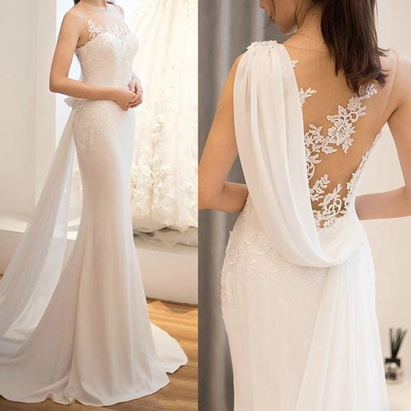 a flowing white lace mermaid wedding dress with intricate lace detailing and a sheer draped back panel designed as a super fairy light wedding dress