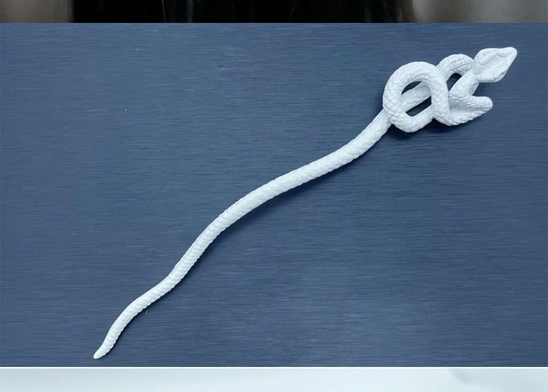 White knotted rope retro style hairpin shaped like a textured snake with a coiled head and elongated body.