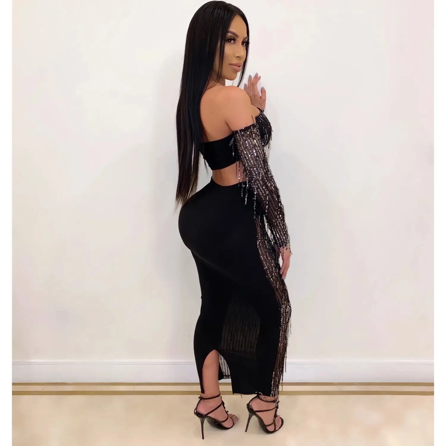 Black off-the-shoulder dress featuring shimmering silver mesh sequins tassel sleeves and fringe detailing for a fashion sexy look.