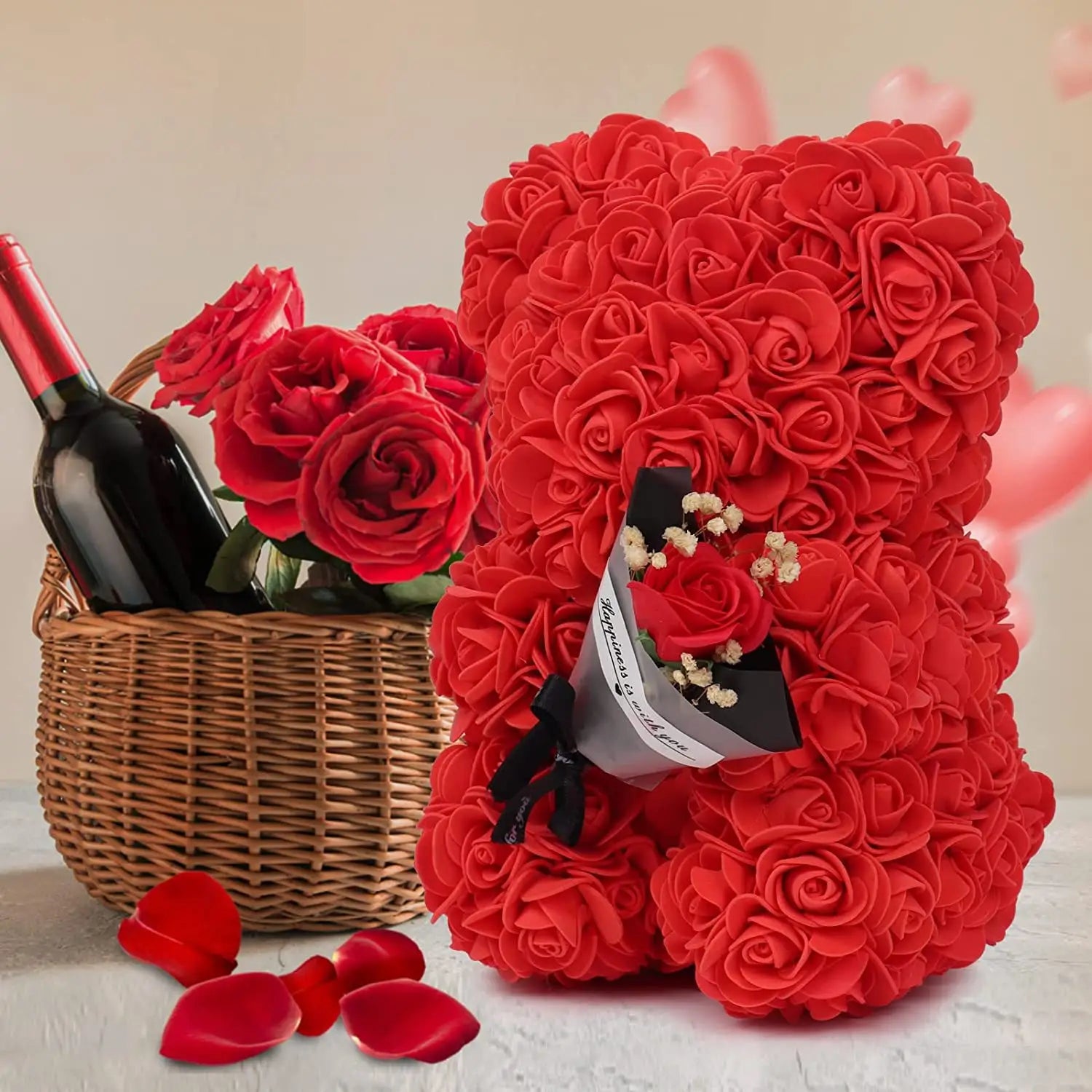 a plush red rose bear made of preserved rose artificial petals holding a small bouquet of flowers in its paw presented in a flower gift box