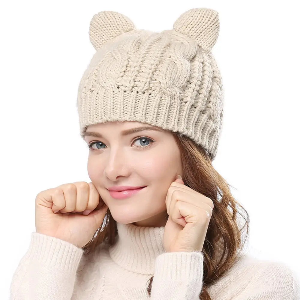 black textured cute knitted cat ear beanie made of beige knitted fabric featuring 3d cute textured cable patterns and soft rounded cat ear accents.