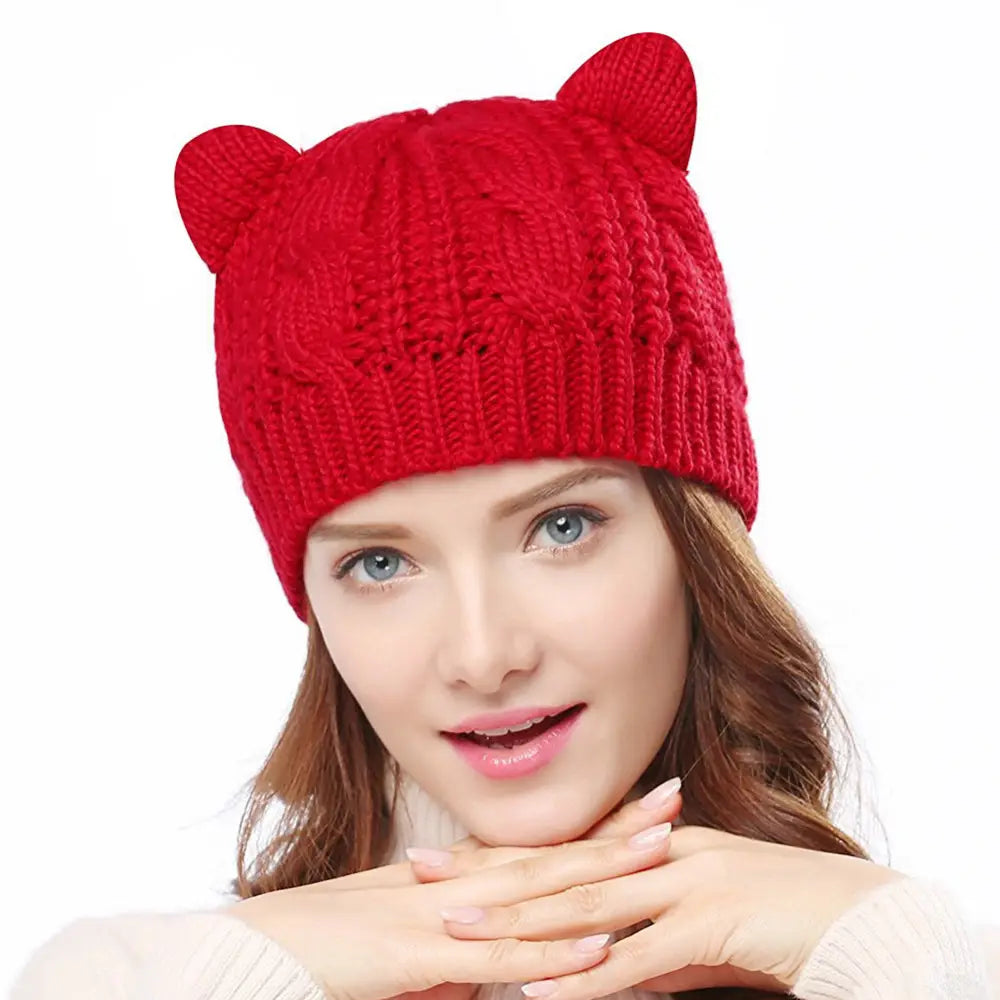 A vibrant red knitted cat ear beanie made with a textured cable pattern featuring two soft rounded ears, designed as a cute knitted cat accessory.