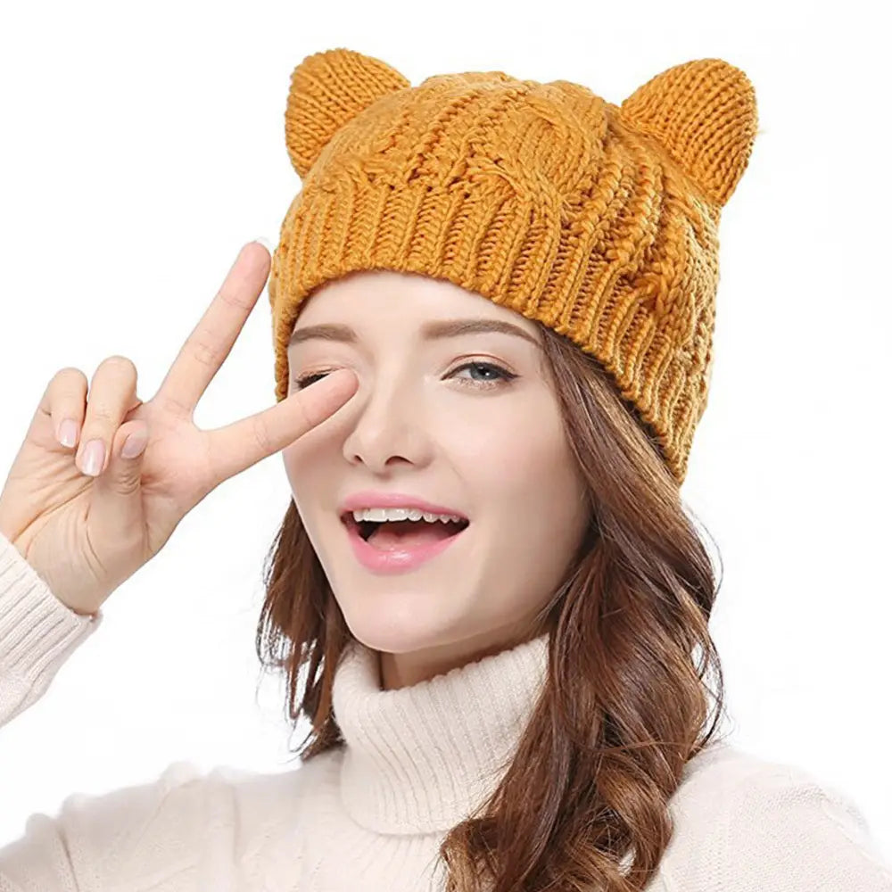 a cozy mustard-yellow knitted cat ear beanie made 3d cute with soft plush ears showcasing a cute knitted cat design