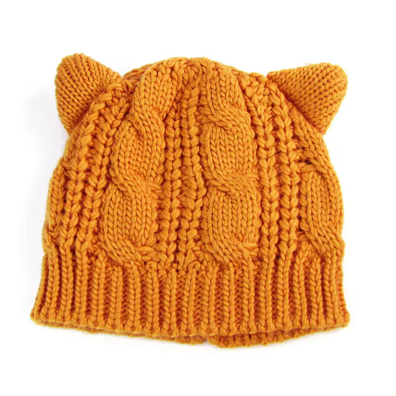 A warm orange cable-knit beanie made 3d cute with soft plush knitted cat ears on top.
