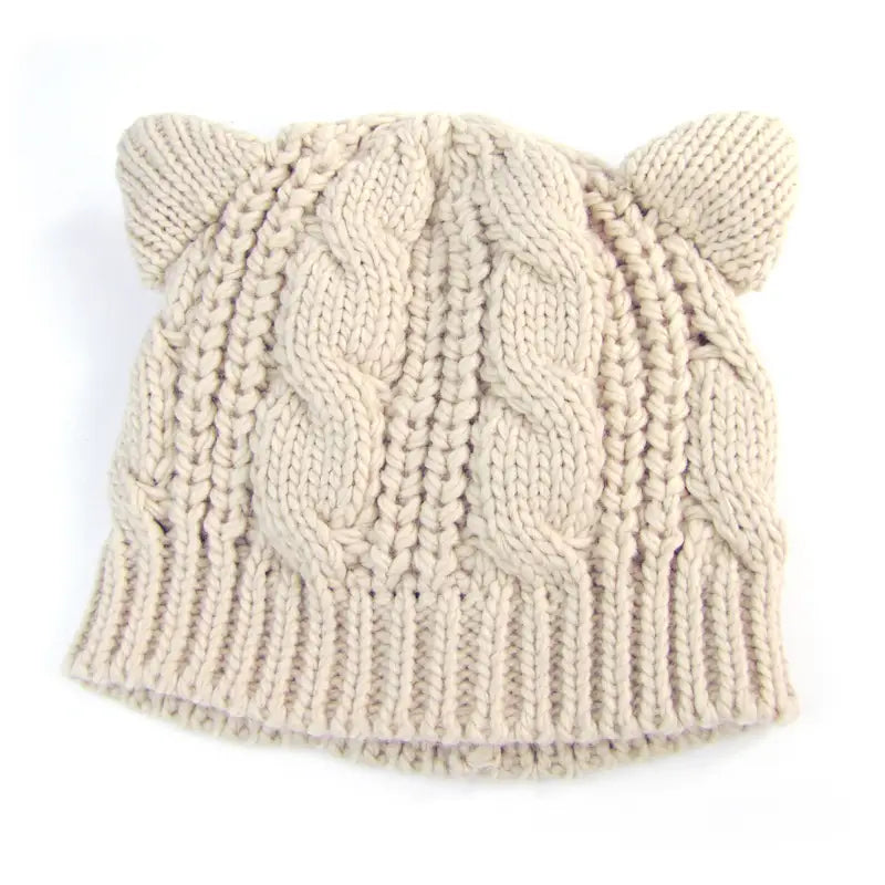 cream-colored knitted cat ear beanie with cable knit pattern and soft rounded accents made 3d cute and featuring a textured design.