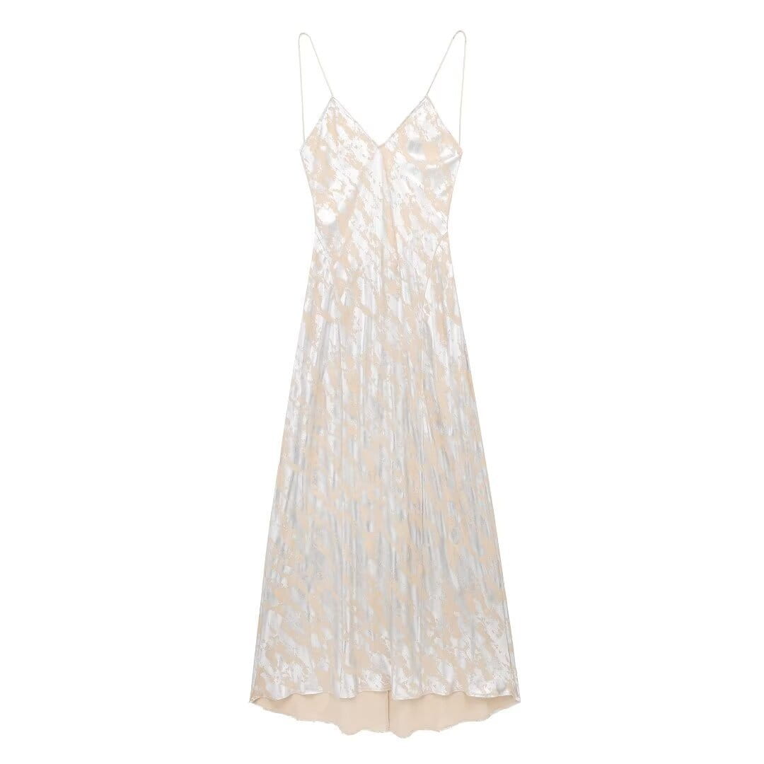A shimmering ivory satin slip dress with delicate spaghetti straps and a subtle textured pattern featuring metal foil printed details in a foil printed underwear dress design.