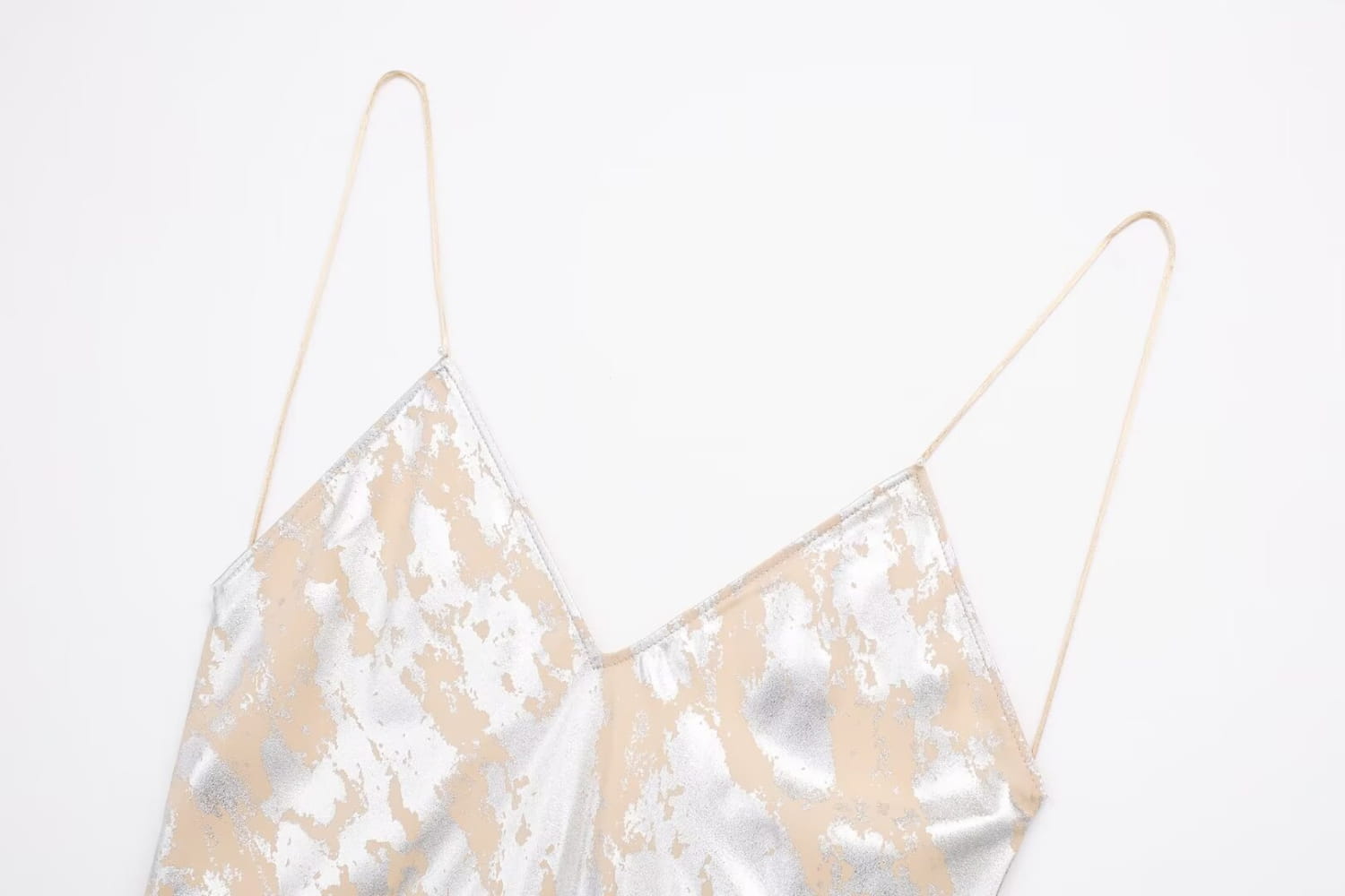 A shimmering silver and gold satin metal foil printed camisole with delicate spaghetti straps featured as a foil printed underwear dress.