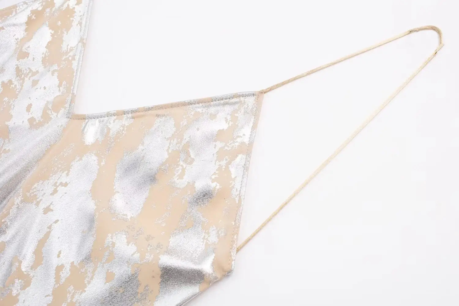 A shimmering metallic apron with a distressed two-tone finish in silver and beige featured as part of a silver satin metal foil printed underwear dress.