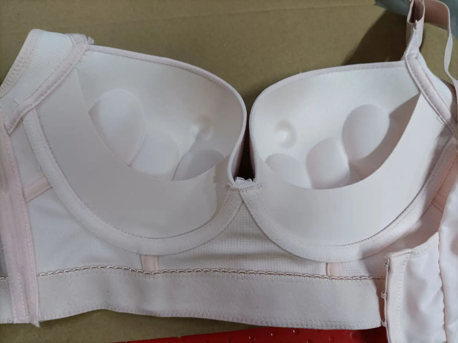 white padded plus size bra with soft pink trim and adjustable straps designed as a seamless black plus size bra without wire