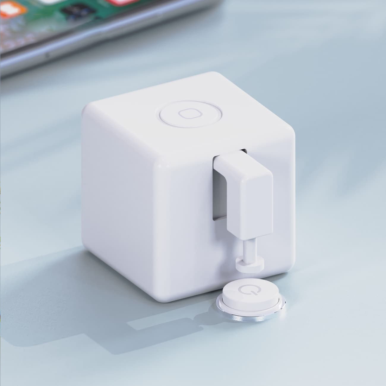 white cube-shaped smart bluetooth finger robot plug with a circular power button on top and a detachable matching white cap designed for voice control finger robot applications.