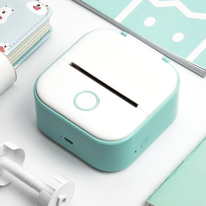 Mint green and white portable mini label printer with a circular button on top designed for rolls sticky paper and easy label printing.