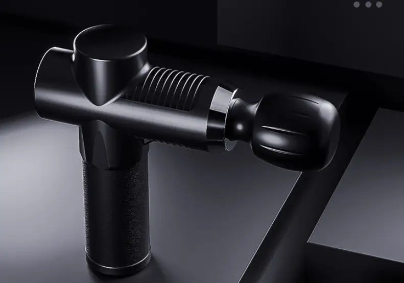 Black handheld massage gun with textured grip and ribbed handle designed as adjustable muscle fitness equipment for effective muscle fitness and recovery.