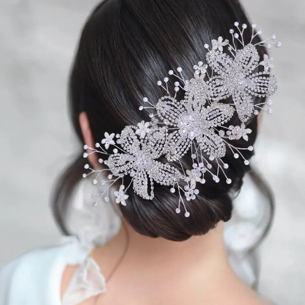 Silver flower rhinestone hair accessory featuring delicate silver rhinestones, intricate lace-like patterns, and dangling crystal beads, ideal for weddings.