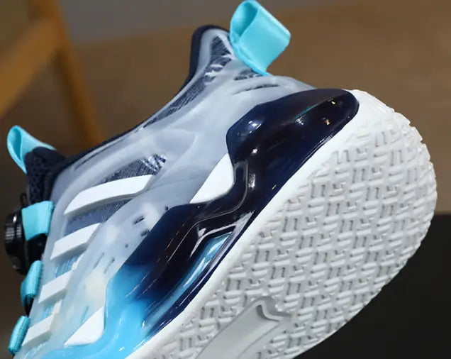 a sleek translucent blue and white athletic shoe with a glossy navy heel accent and light blue laces from the teal gradient shoes rotating button boy collection featuring dual network sdx technology