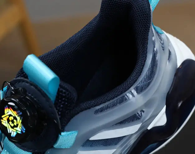 Black and translucent dual network sdx shoes rotating button boy featuring turquoise accents and a distinctive circular logo on the side in teal gradient shoes rotating button style.