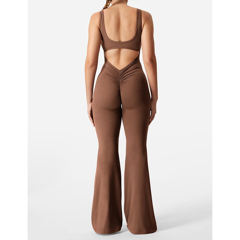 a sleek chocolate brown slim fit hip raise jumpsuit with a flattering back cutout and ruched detailing at the waist shown from the back side