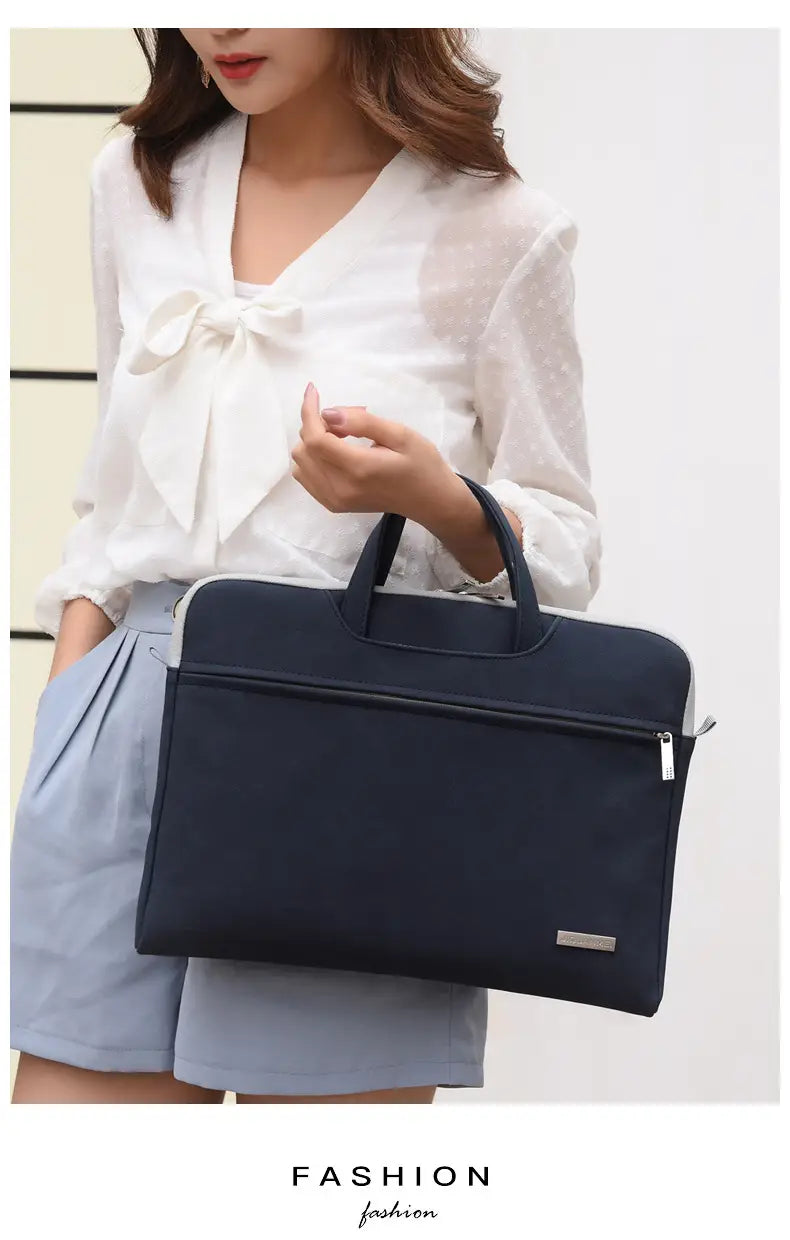 Navy blue leather women laptop bag with black handles and silver zipper pulls designed as a stylish women laptop bag with pouch.