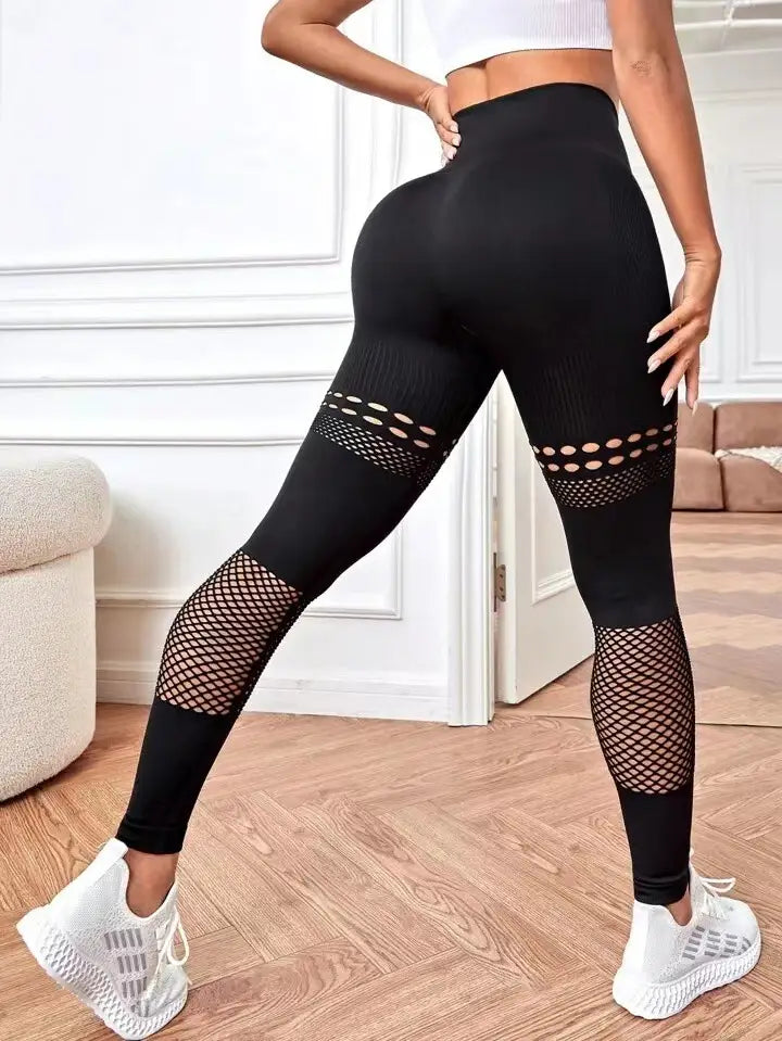black high-waisted hollow seamless yoga pants with mesh paneling on the thighs and calves designed for yoga pants training