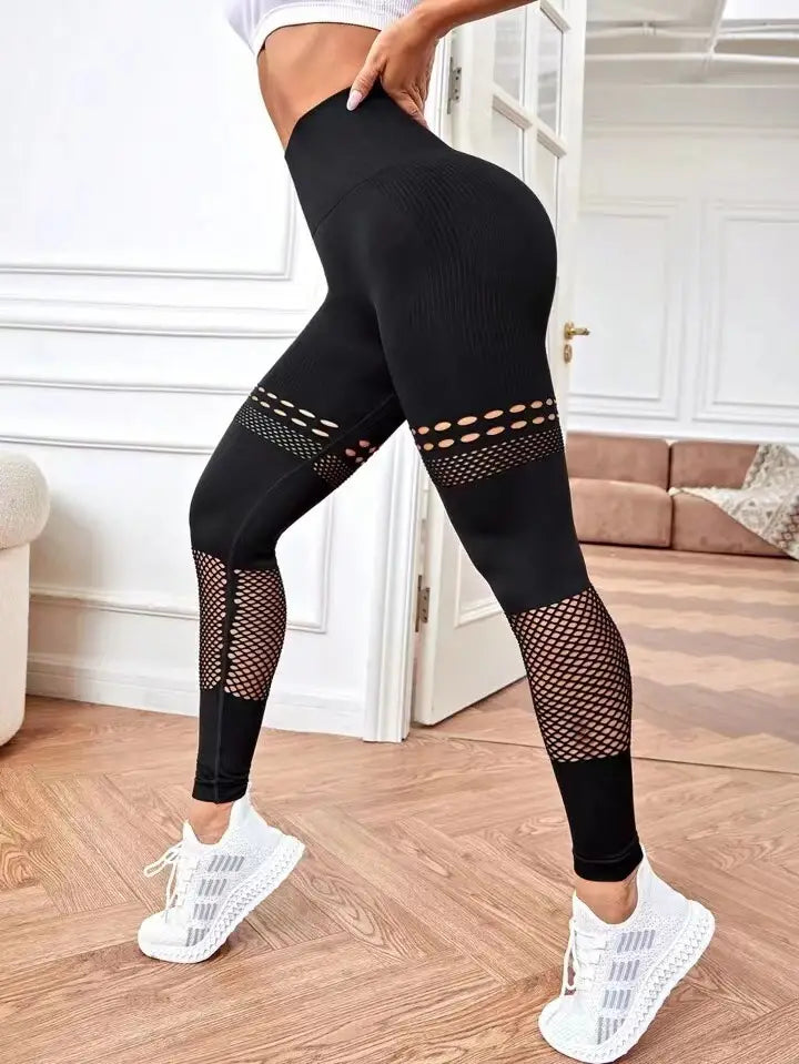 black high-waisted hollow seamless yoga pants with mesh panels featuring a snug form-fitting design for yoga pants training
