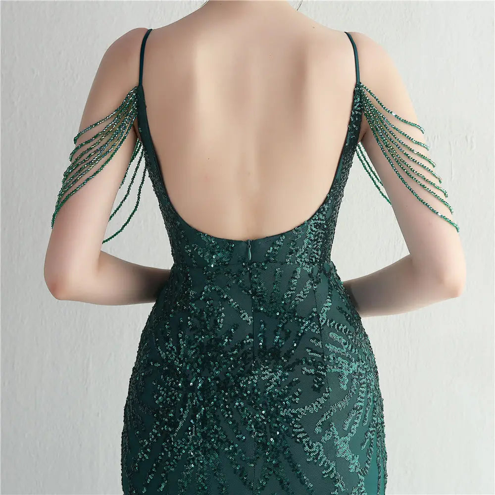 Emerald green sequined evening gown with delicate shoulder chains designed as a mesh beaded bridal wedding dinner gown.