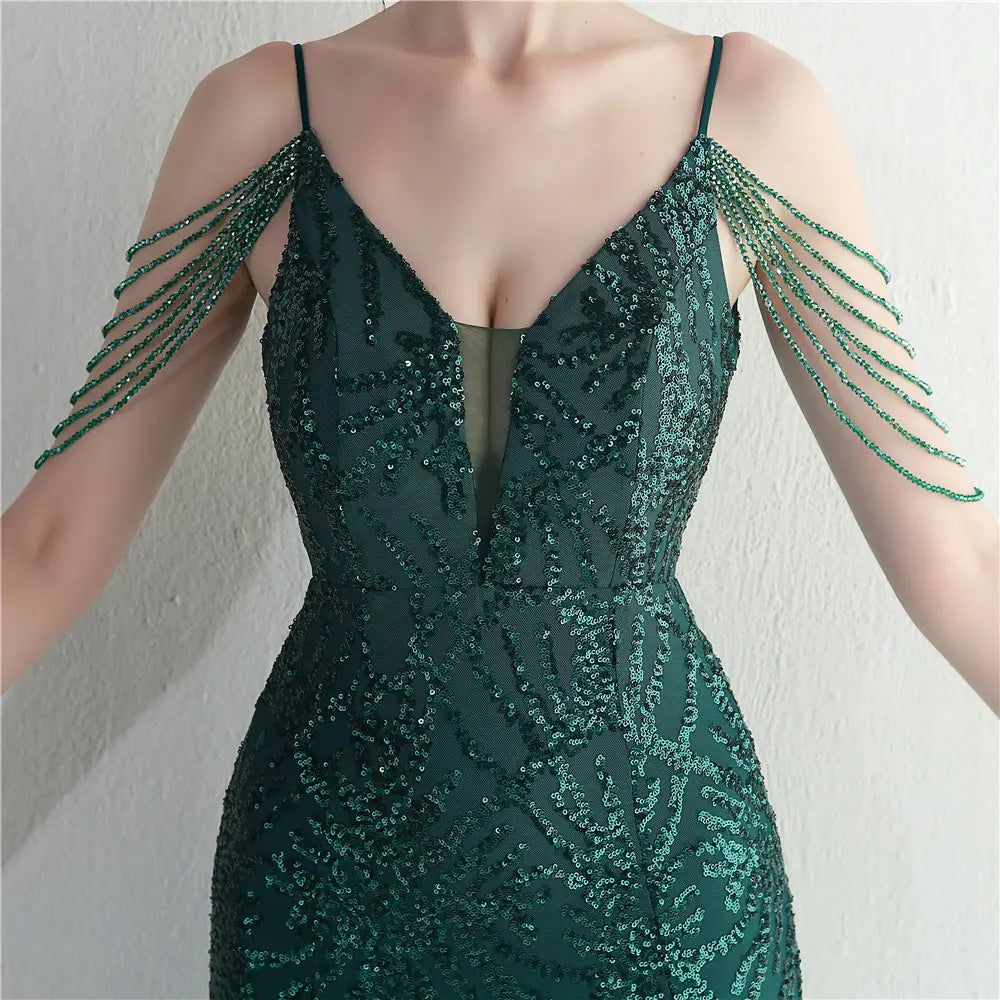 Emerald green sequined evening gown with delicate beaded shoulder straps showcasing a mesh beaded bridal wedding dinner style.