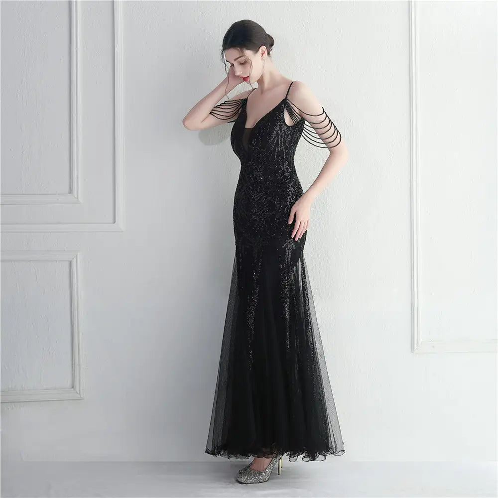 black sequined mermaid gown with sheer overlay and delicate shoulder straps featuring mesh beaded bridal detailing for a bridal wedding dinner.