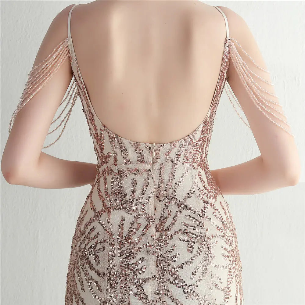 a shimmering rose gold sequined evening gown with delicate spaghetti straps and cascading beaded shoulder chains designed as a mesh beaded bridal wedding dinner gown