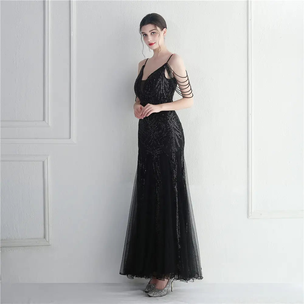 Elegant black mesh beaded bridal wedding dinner gown featuring a sequined mermaid silhouette with sheer overlay and delicate arm straps.