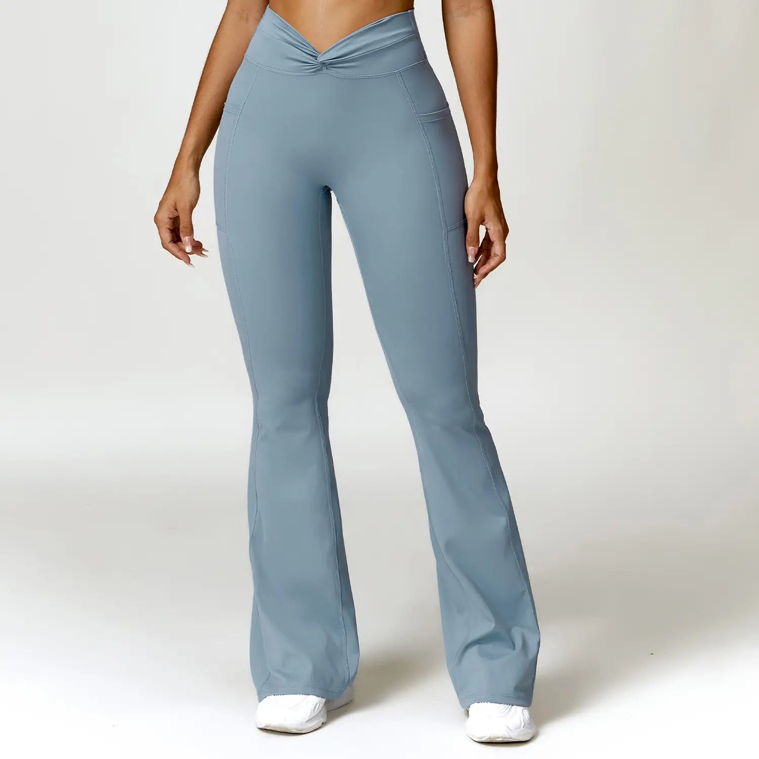 light blue high-waisted flared leggings featuring a twisted front waistband and side pockets designed for american hip raise and hip raise high waist activities.