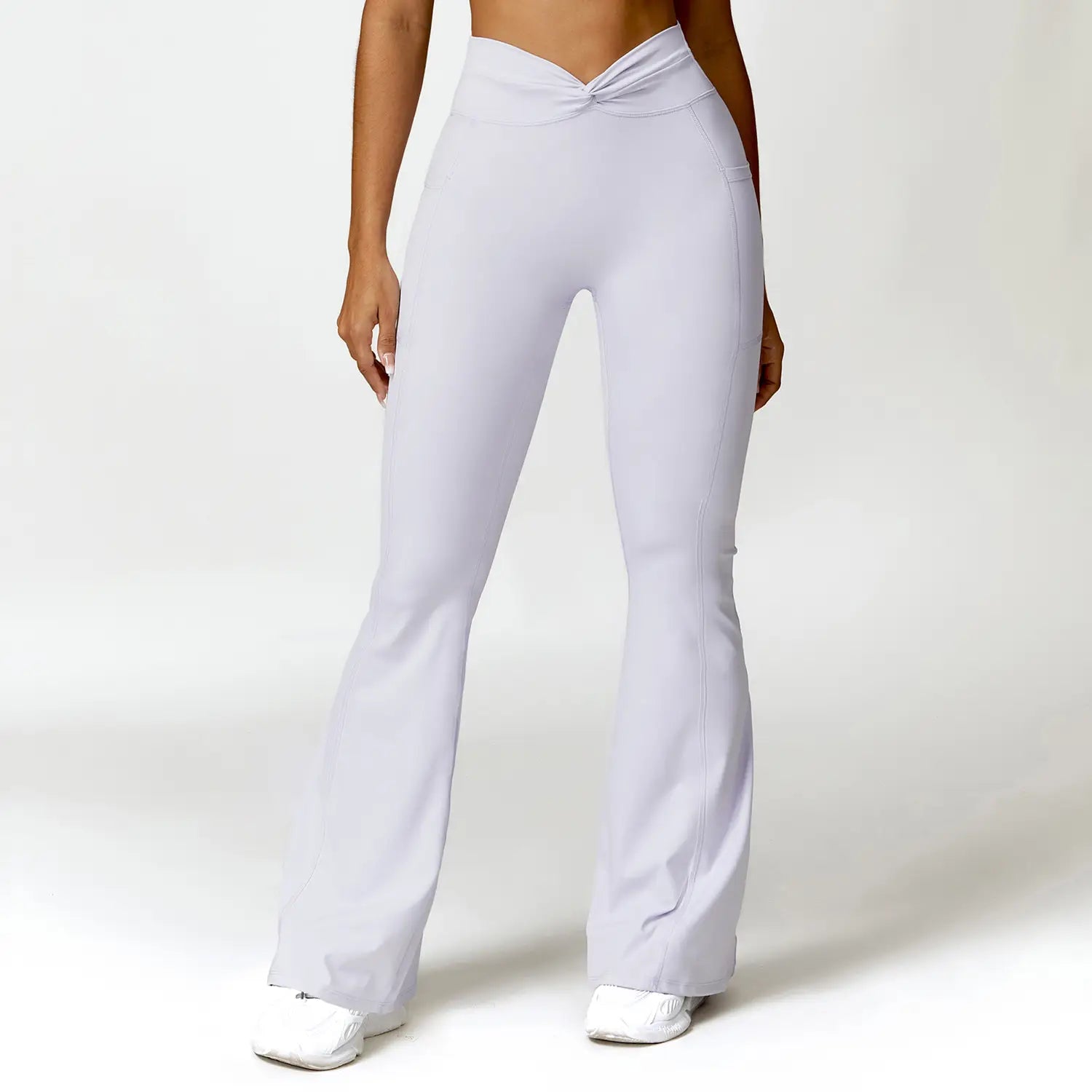light gray high-waisted flared leggings with a twisted front waistband designed for american hip raise and hip raise high waist yoga activities.